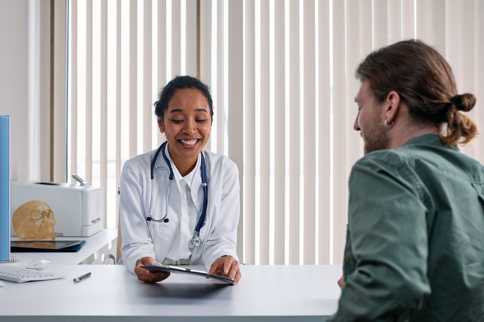 Doctor talking with a patient during a consultation, representing access to healthcare through a health membership