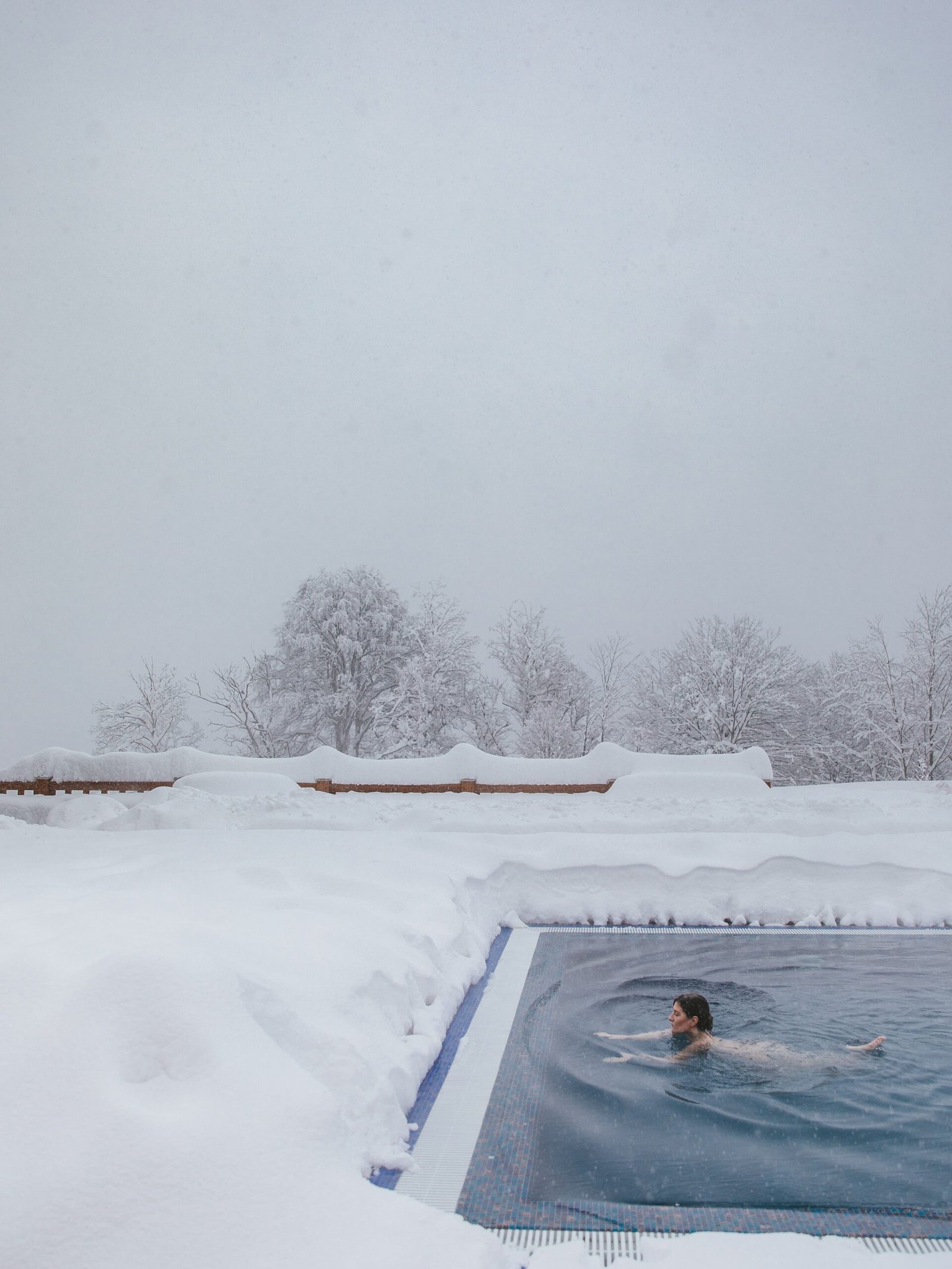 Person swimming in cold water outdoors during winter, illustrating cold exposure benefits