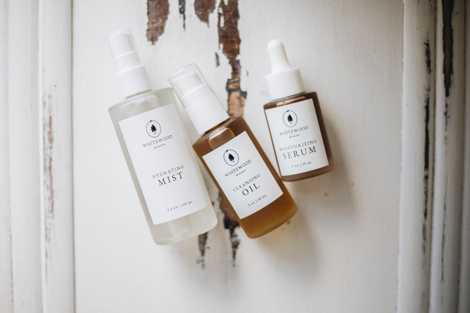 Flat lay of skincare serum bottles on a rustic background, illustrating a niacinamide skincare routine