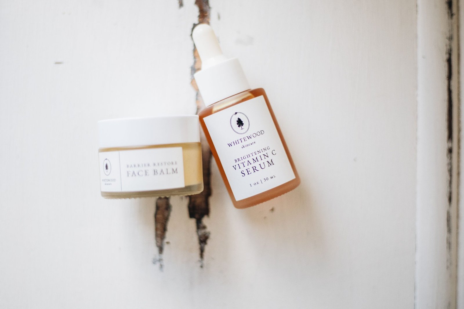 Elegant flat lay of natural skincare products including a vitamin C serum bottle
