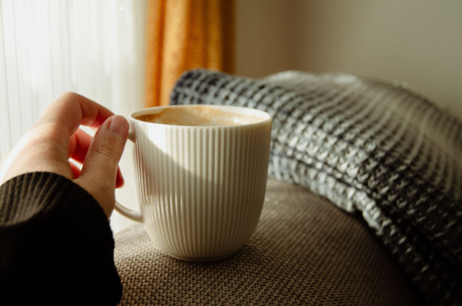 Cup of coffee in sunlit room, part of a calm and structured morning routine