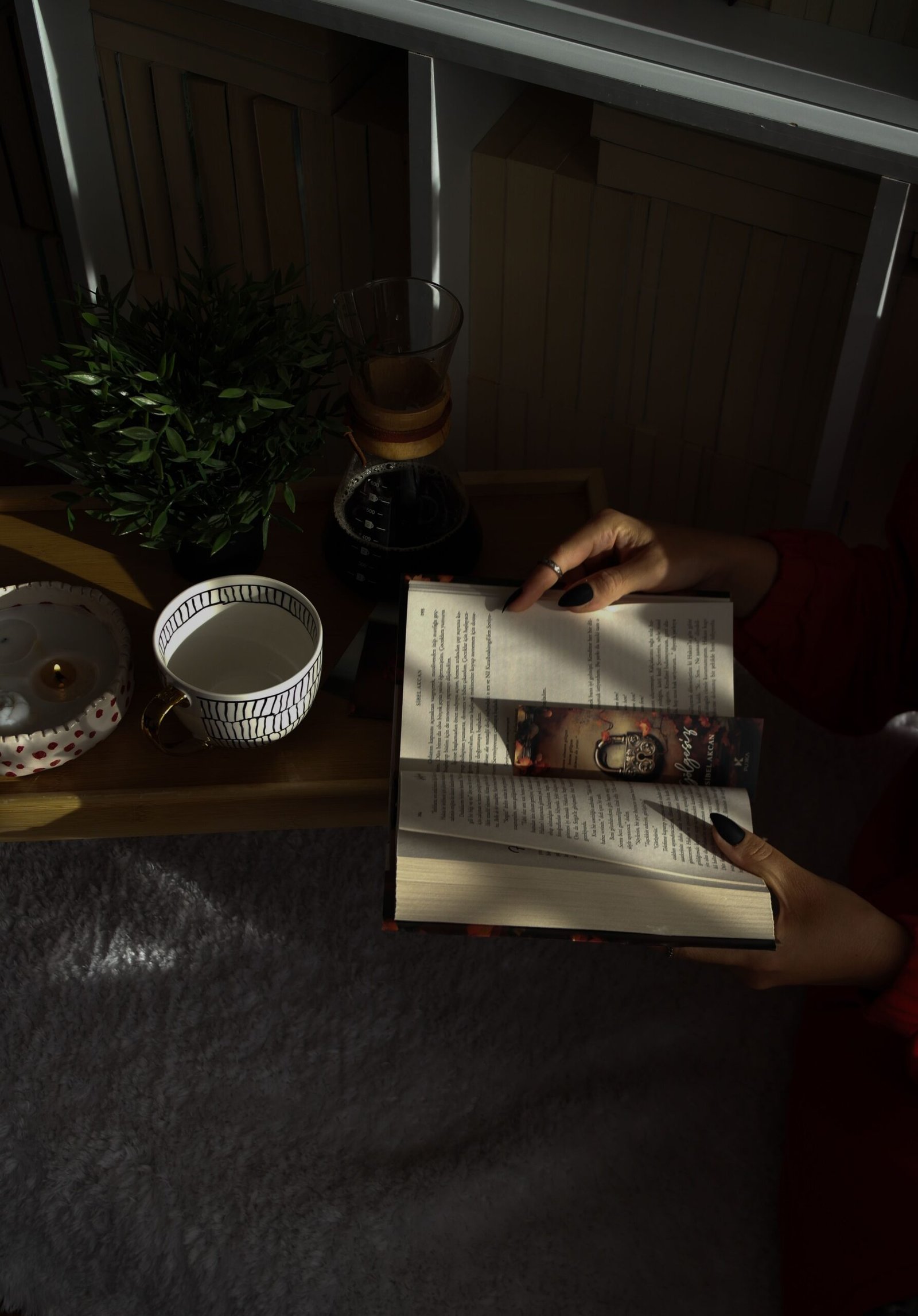 Cozy reading nook with a book and cup of tea, part of a calming evening wind-down routine