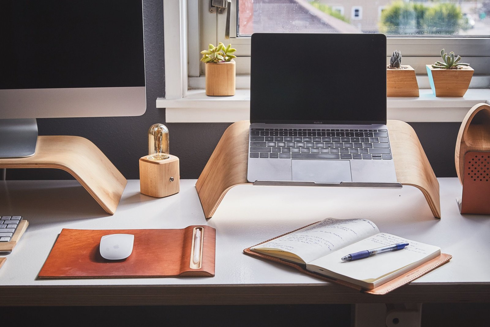 A calm, organized home office desk with a laptop, symbolizing healthy work-life boundaries