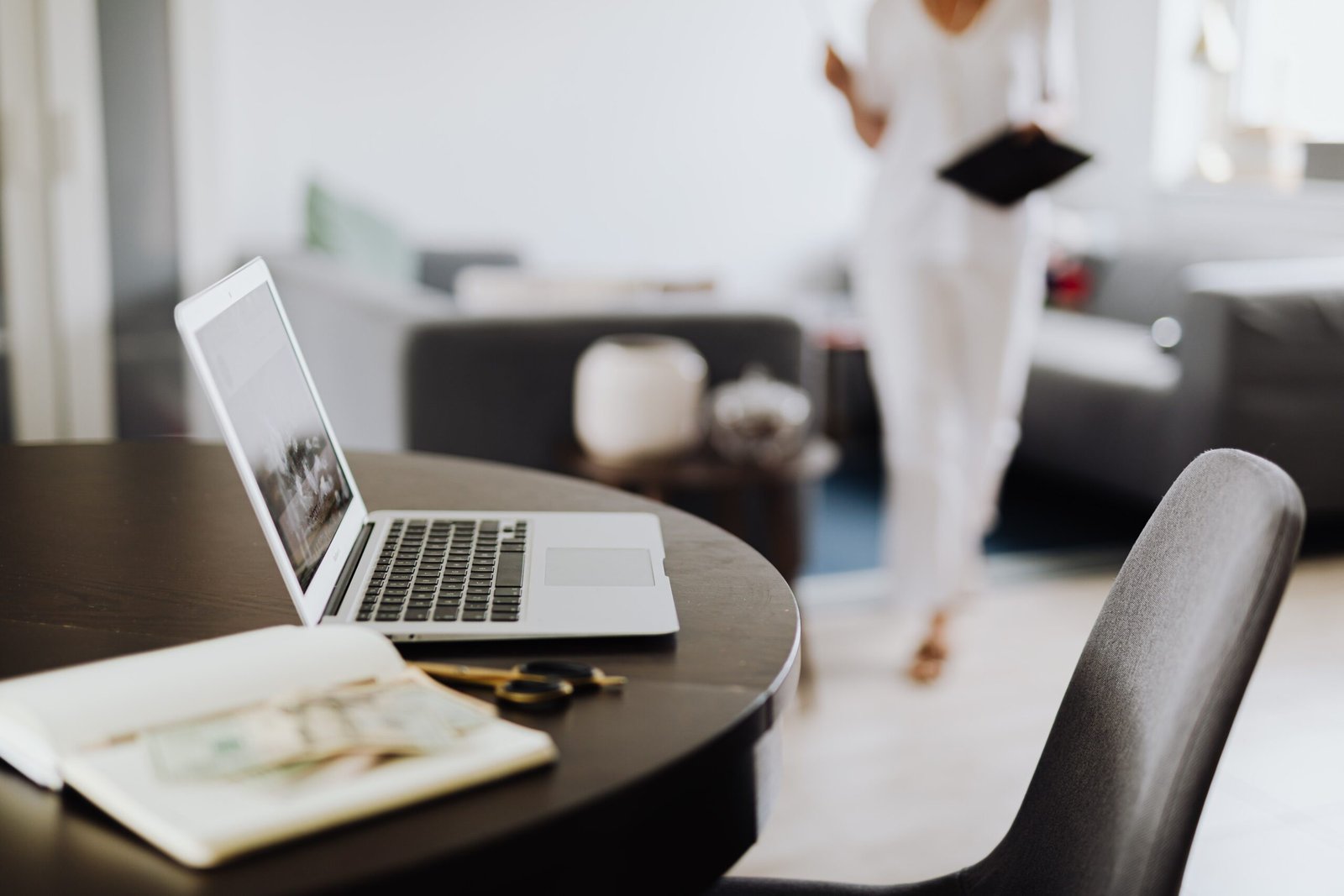 Tidy office desk with a laptop and notebook, representing a healthy boundary between work and personal time