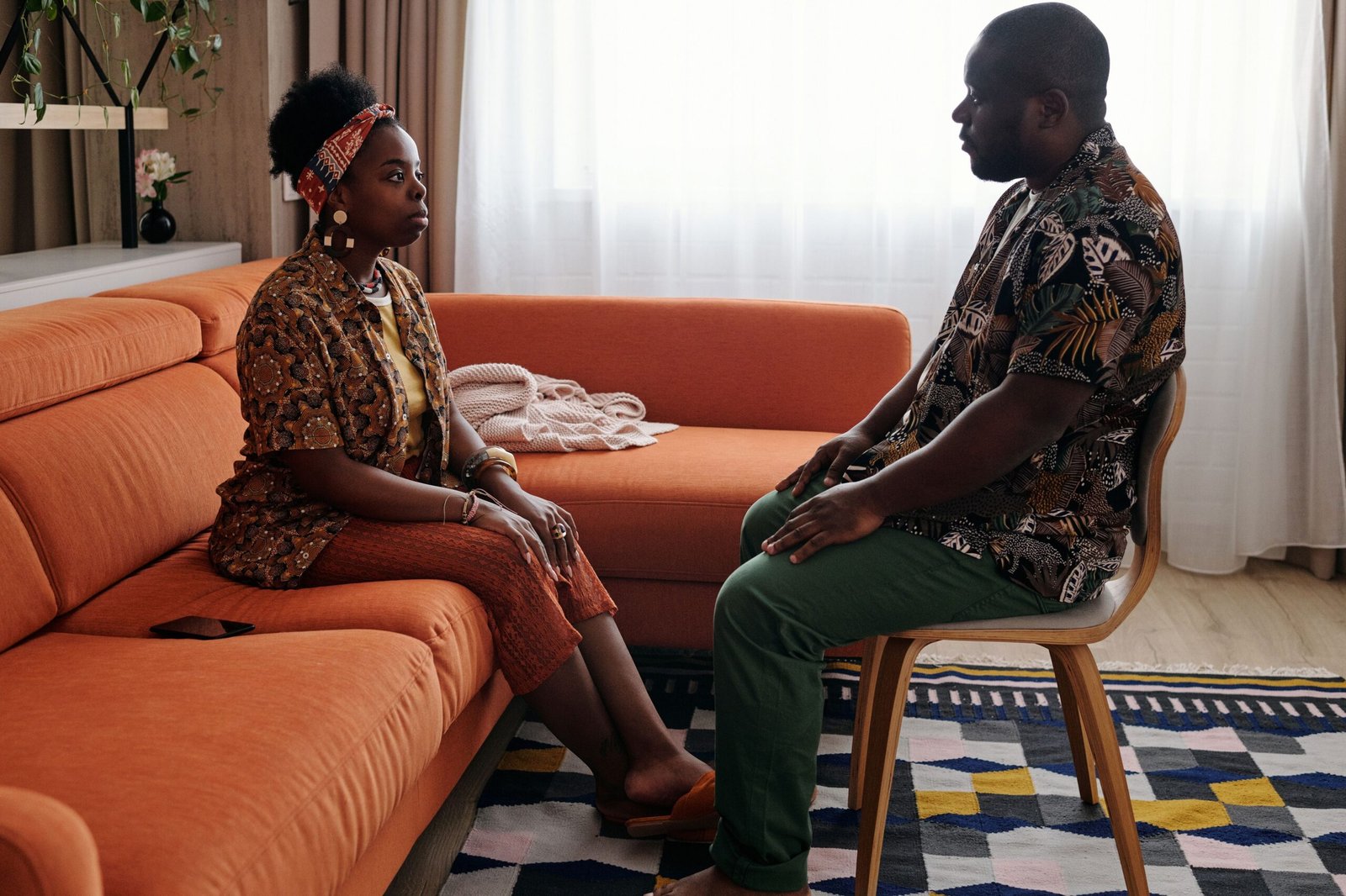 Couple having a thoughtful, serious conversation at home about relationship patterns
