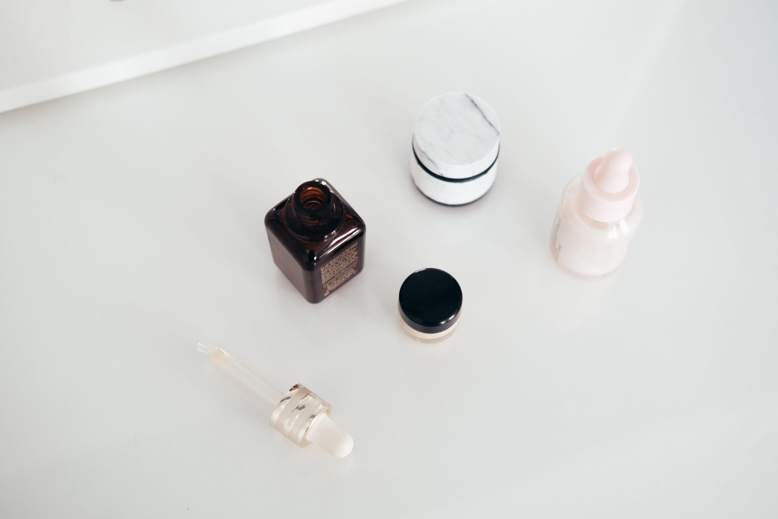 Flat lay of moisturizers and skincare jars, used to help repair a damaged skin barrier