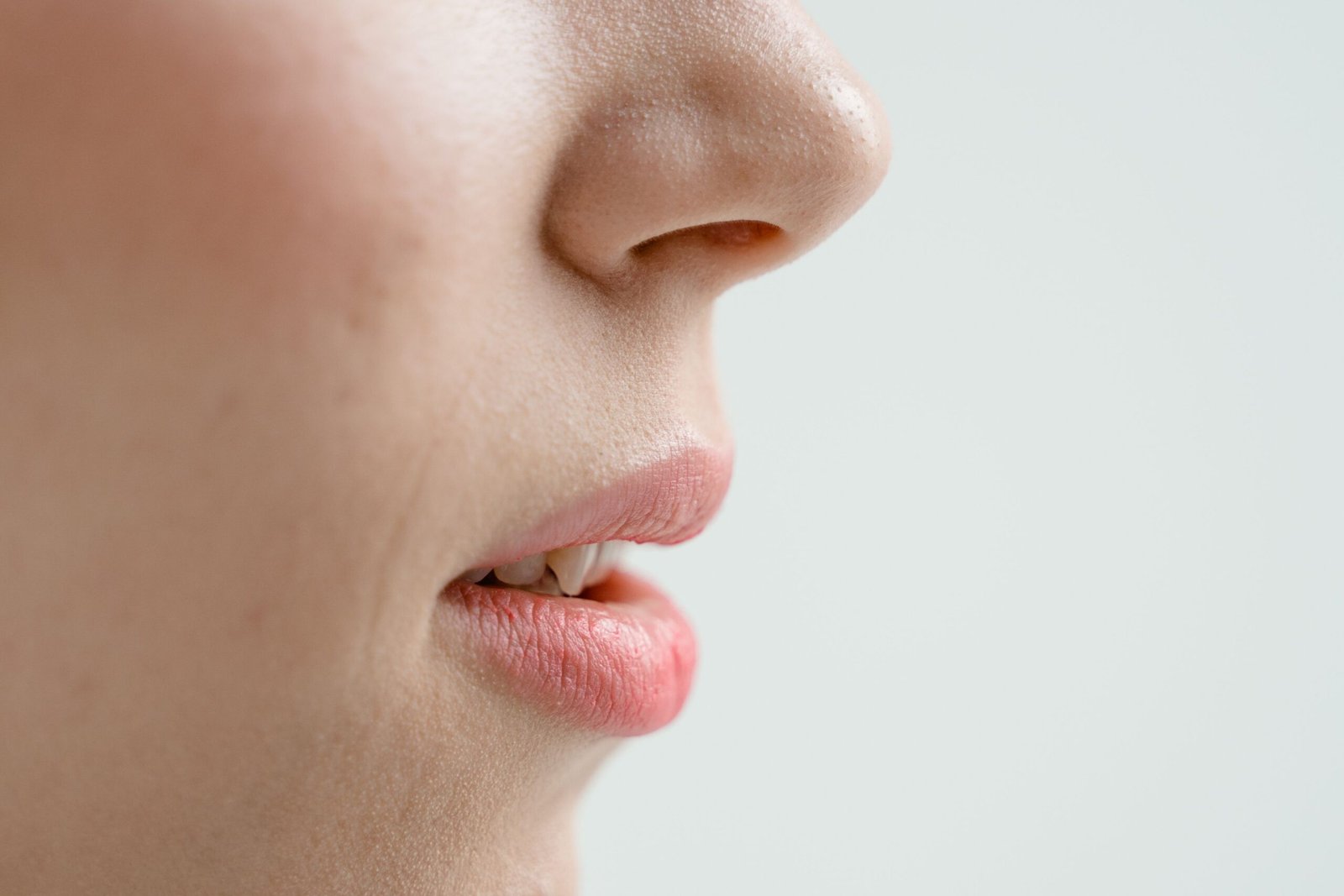 Close-up of a woman's lower face and jawline, showing skin structure relevant to jowls