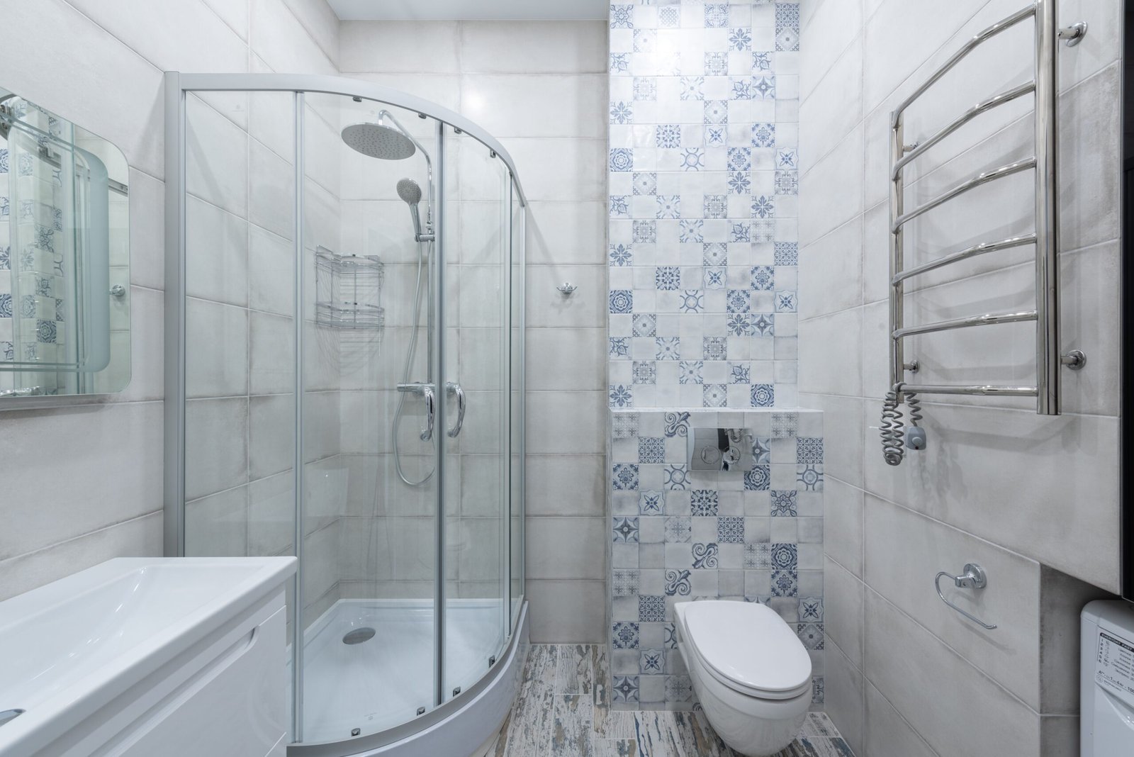 Bright, clean modern bathroom with glass shower and tiled walls, the environment where loofah sponges are used